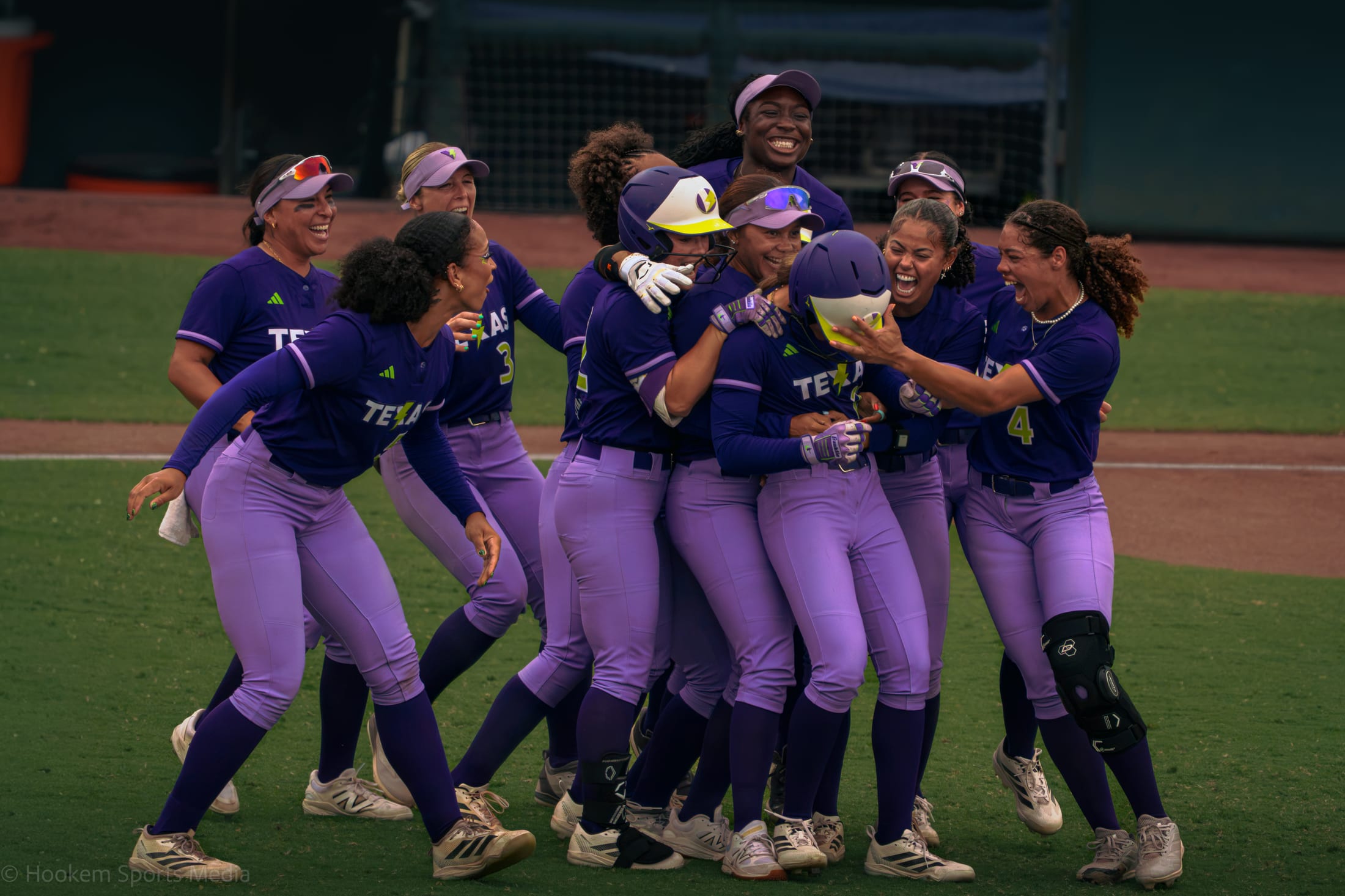 Texas Volts pile onto Jackie Lis after the walk-off win.