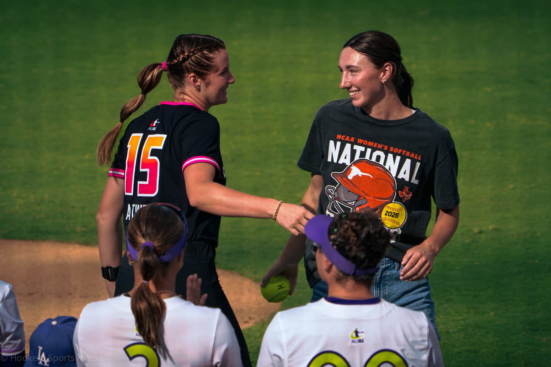 Teagan Kavan hugs Reese Atwood after throwing the ceremonial first pitch on Champions Night.