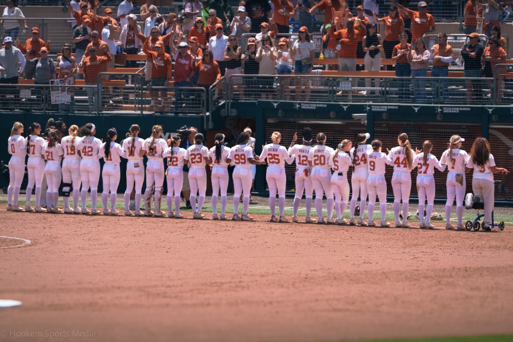 Texas softball lines up facing a packed McCombs Field crowd at a home game.