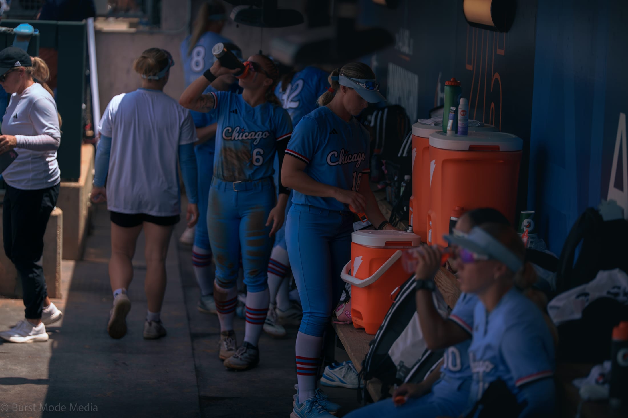 Chicago Bandits players hydrate in the dugout during Game 1 at Davis Diamond.
