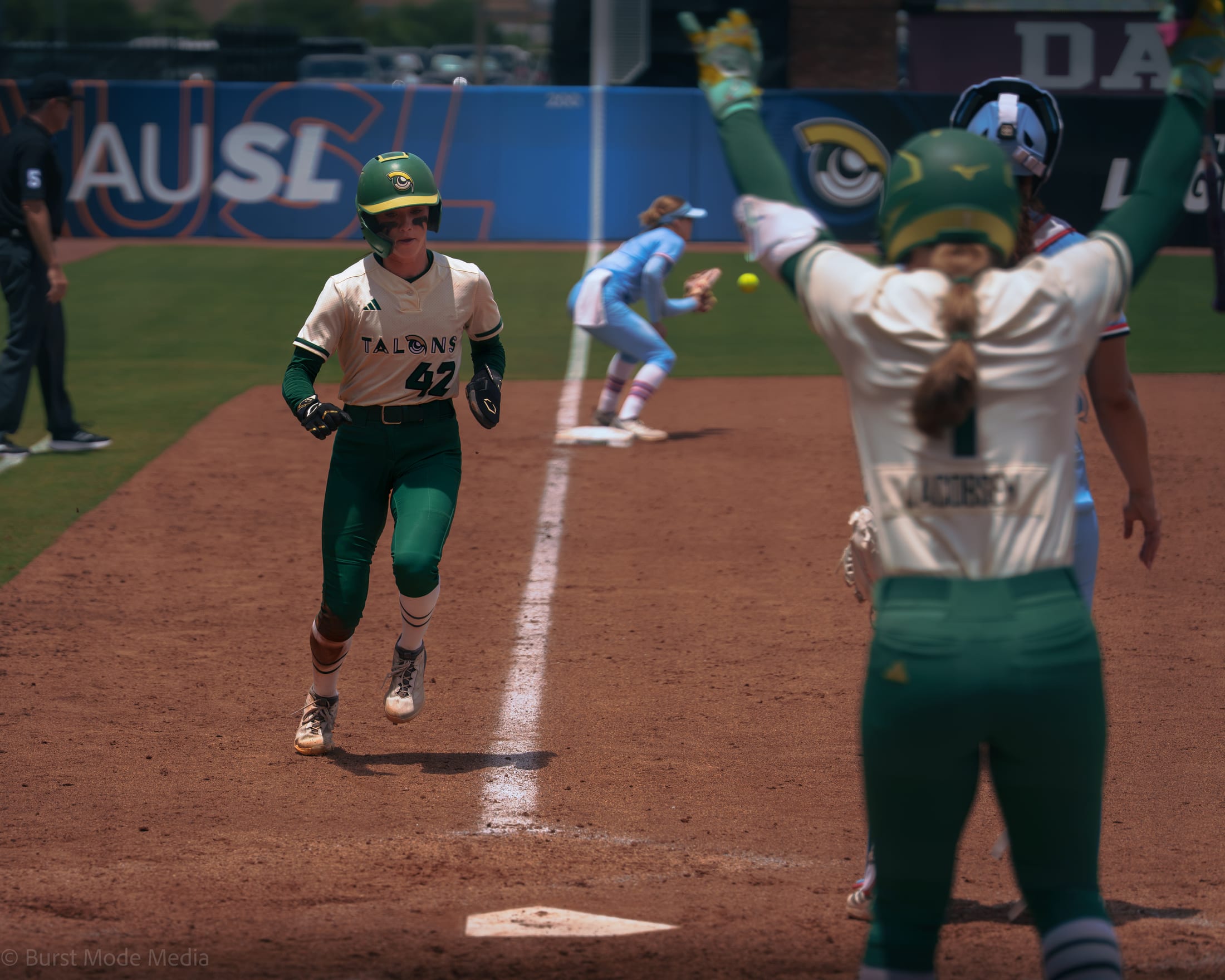 Caroline Jacobsen celebrates as Jadelyn Allchin scores the go-ahead run in the sixth.